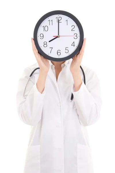 Junge Ärztin mit Büro-Uhr über ihr Gesicht, isoliert — Stockfoto