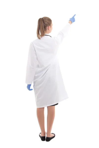 Back view of young woman doctor pointing at something isolated o — Stock Photo, Image