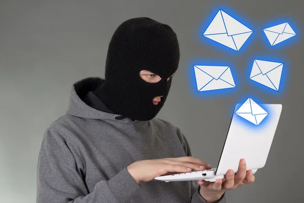 Hacker in mask stealing data from e-mail — Stock Photo, Image