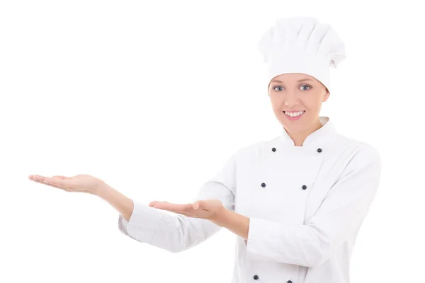 Young woman chef showing or presenting something isolated on whi — Stok Foto