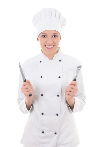 Young woman in chef uniform with fork and knife isolated on whit Stock Photo