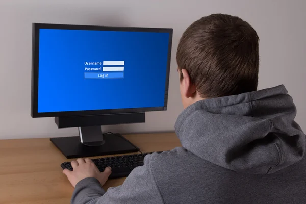 Young man typing username and password — Stock Photo, Image