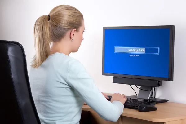 Back view of woman using personal computer in office — Stock Photo, Image