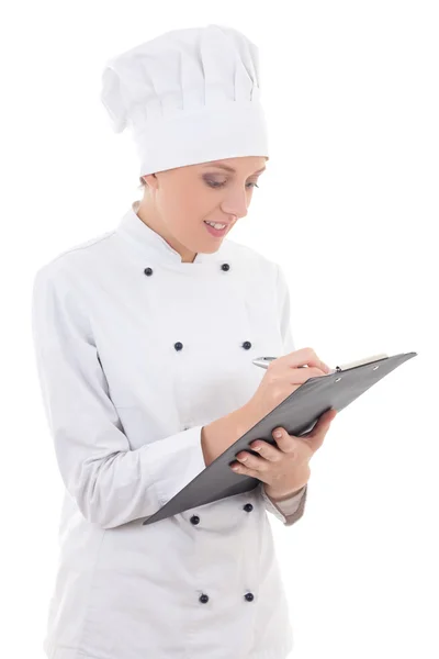 Young woman in chef uniform writing something in clipboard isola — Stock Photo, Image