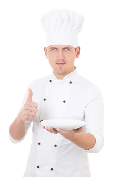 Young man chef  in uniform thumbs up and showing empty plate iso — Stock Photo, Image