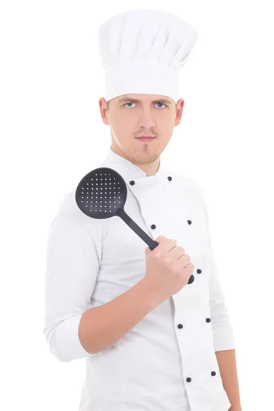 Young man in chef uniform with sauce spoon isolated on white — Stock Photo, Image