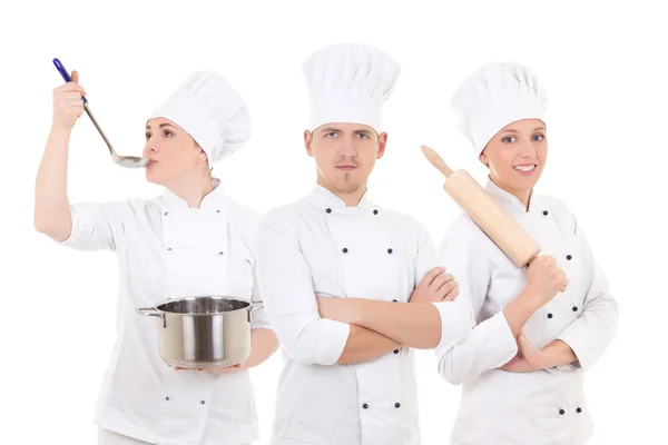 Cocina concepto - tres jóvenes chefs aislados en blanco — Foto de Stock