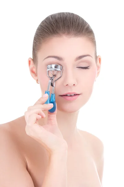 Portrait of young beautiful woman curling her eyelashes isolated — Stock Photo, Image