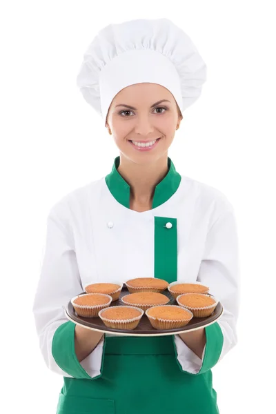 Ung chef kvinna i enhetlig visar bricka med muffins isolerad o — Stockfoto