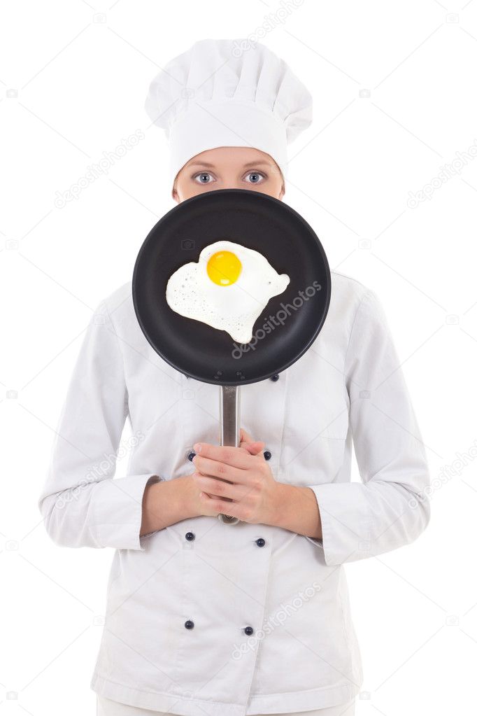 woman in chef uniform holding skillet with frying egg behind her