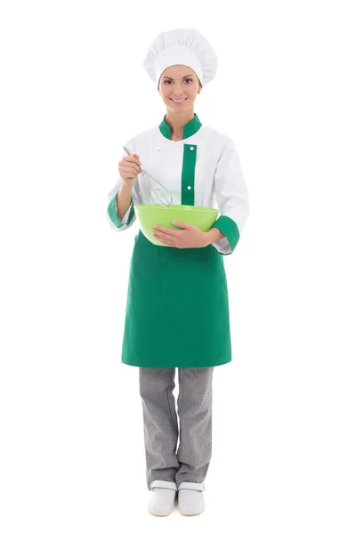 Mujer joven en uniforme de chef mezcla algo en bo plástico verde —  Fotos de Stock