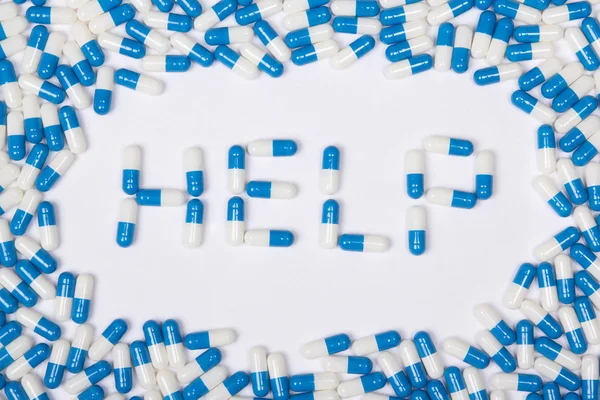 Texto de word ayuda hecha de cápsulas, píldoras y pastillas azules —  Fotos de Stock