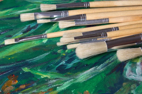 Set of paint brushes on oil paints — Stock Photo, Image