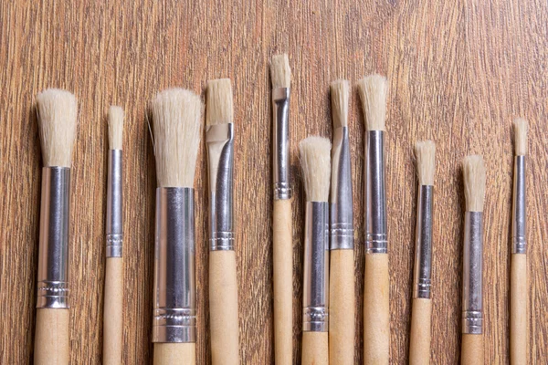 Wooden paint brushes on table background — Stock Photo, Image