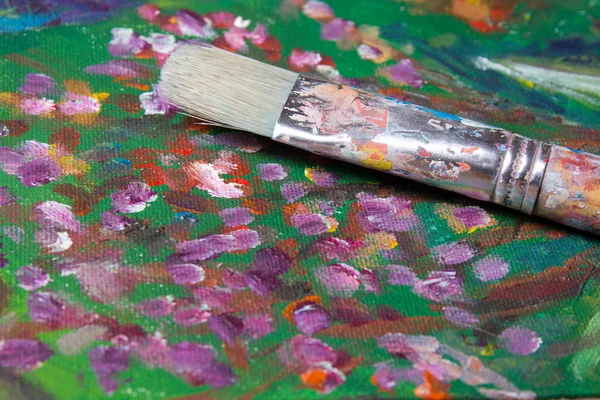 Used paint brush on canvas background — Stock Photo, Image