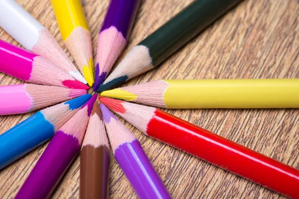 Close up of colorful drawing pencils on wooden table — Stock Photo, Image