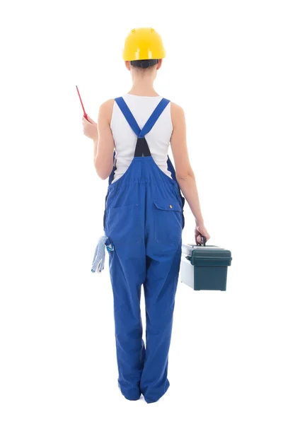 Back view of young beautiful woman builder in workwear with tool — Stock Photo, Image