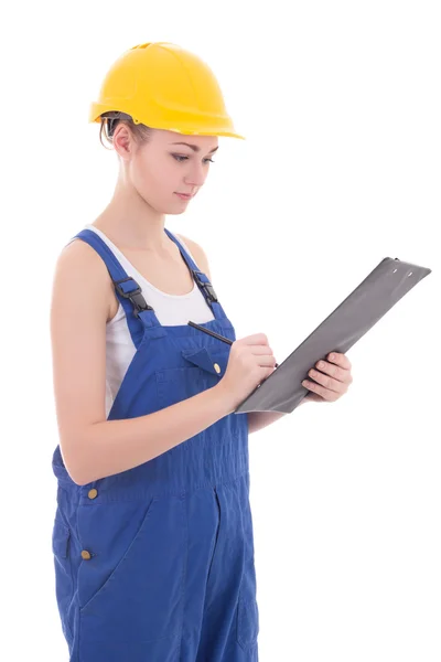 Young attractive woman builder writing something in clipboard is — Stock Photo, Image