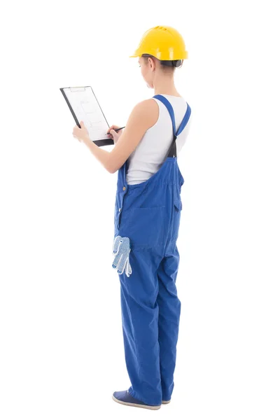 Back view of young woman builder writing something in clipboard — Stock Photo, Image