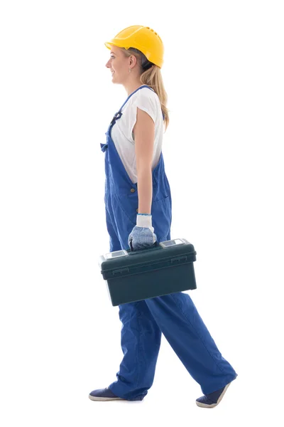 Vue latérale d'une femme marche dans builder bleu uniforme avec la boîte à outils — Photo