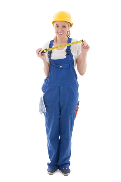 Mujer en azul constructora uniforme y casco con cinta métrica es —  Fotos de Stock