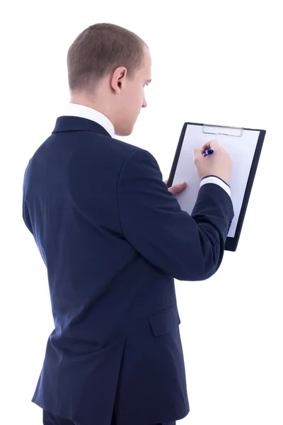 Back view of young businessman in suit writing something in clip — Stock Photo, Image