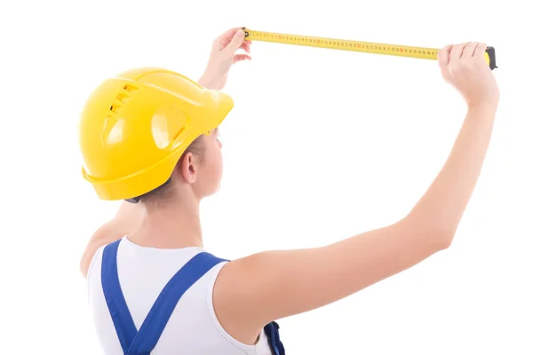 Young beautiful woman builder in blue coveralls with measure tap — Stock Photo, Image