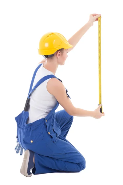 Back view of sitting woman builder measuring something with meas — Stock Photo, Image