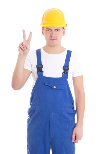 Young handsome man in blue builder uniform showing victory sign — Stock Photo, Image