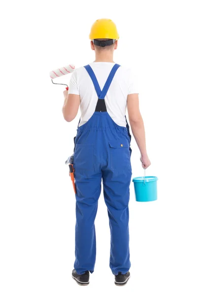 Vista trasera del pintor joven en guardapolvos azules aislado en whi —  Fotos de Stock