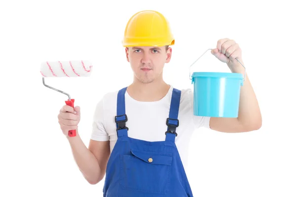 Young man painter in blue coveralls with paint brush and bucket — Stock Photo, Image