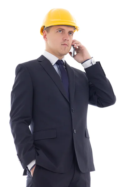 Hombre de negocios guapo joven en casco de constructor amarillo hablando b — Foto de Stock