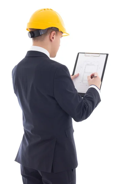 Young handsome business man in yellow builder's helmet writing s – stockfoto