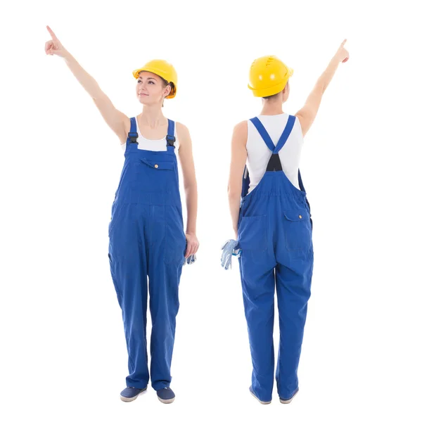 Front and back view of young woman builder pointing at something — Stock Photo, Image