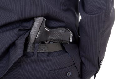 Silah üzerinde beyaz izole iş takım elbise pantolon içinde yakın çekim