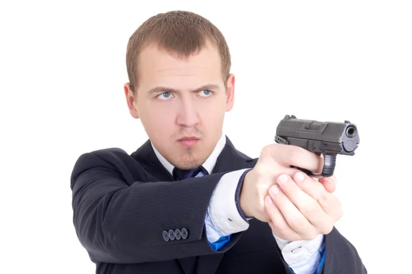 Serious man in business suit shooting with gun isolated on white — Stock Photo, Image