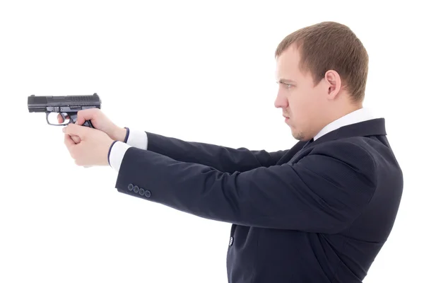 Side view of man in business suit shooting with gun isolated on — Stock Photo, Image