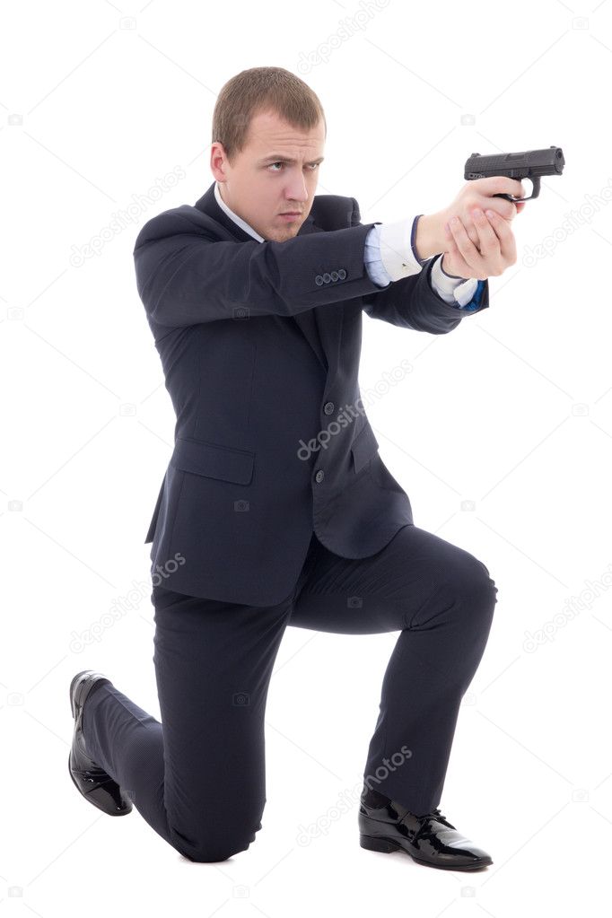 man in business suit sitting on knee and shooting with gun isola