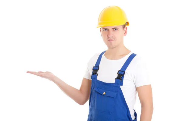 Construtor de homem em uniforme azul e capacete segurando algo na palma da mão — Fotografia de Stock