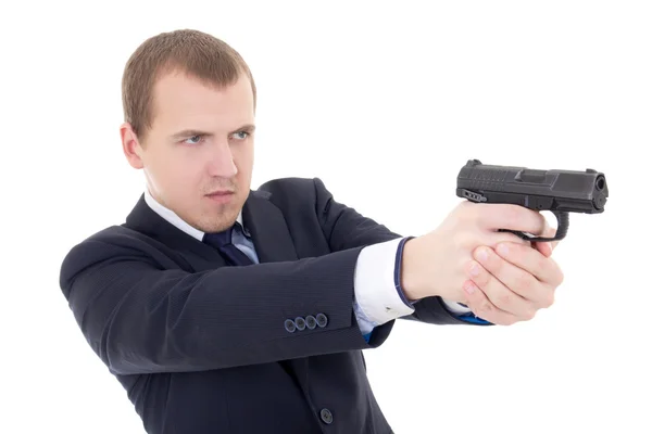 Young man in business suit shooting with gun isolated on white — Stock Photo, Image
