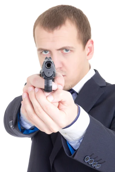 Serious man in business suit aiming gun at camera isolated on wh — Stock Photo, Image