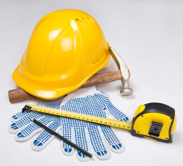 Builder's tools - yellow helmet, work gloves, hammer, pen and me — Stock Photo, Image