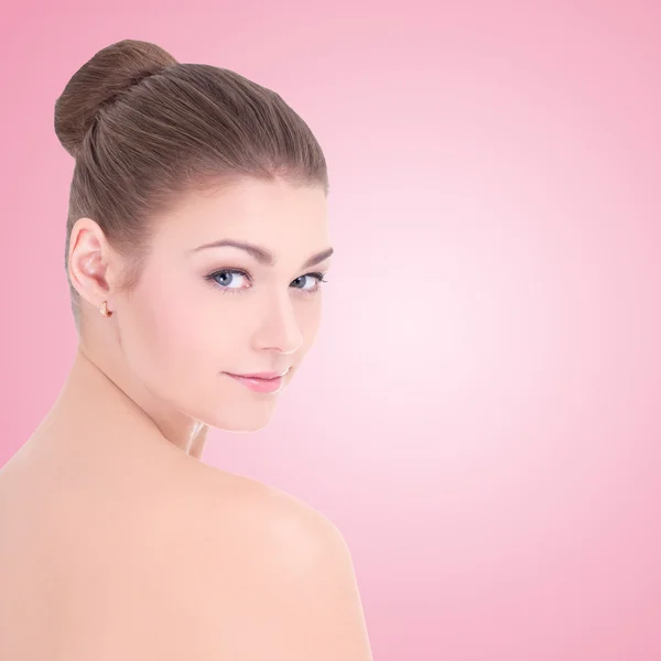 Portrait of young beautiful woman with perfect skin over pink — Stock Photo, Image