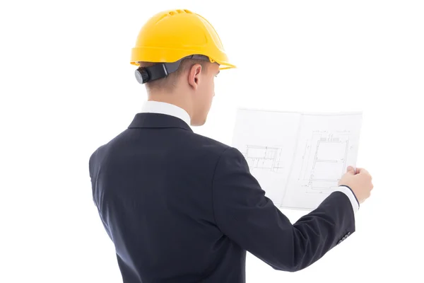 Vista posterior de hombre de negocios en el casco de constructor amarillo con bluepr —  Fotos de Stock