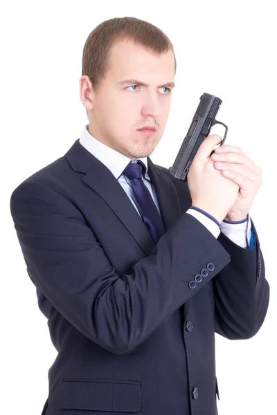 Young serious man in business suit with gun isolated on white — Stock Photo, Image