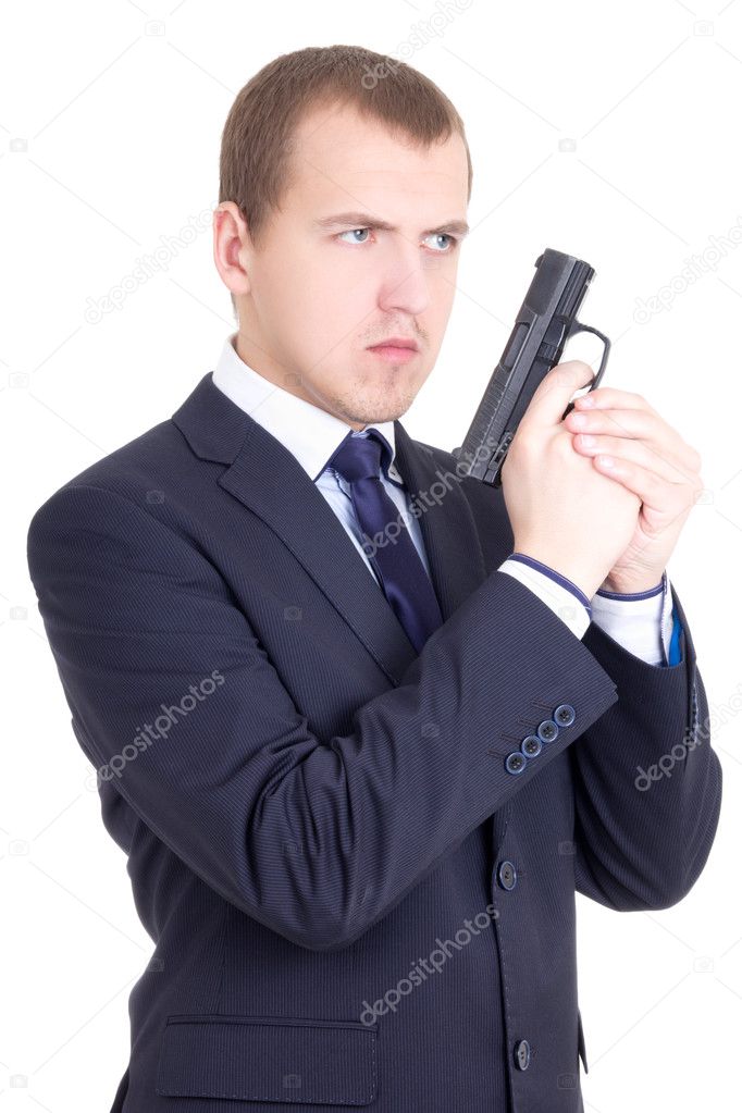 young serious man in business suit with gun isolated on white