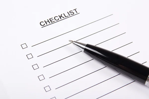 Close up of blank checklist and pen — Stock Photo, Image