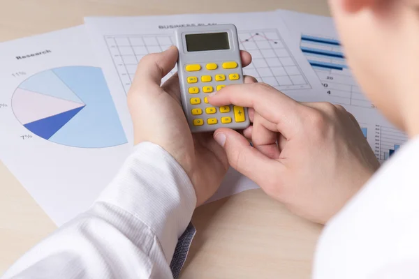 Man accounting something with calculator — Stock Photo, Image