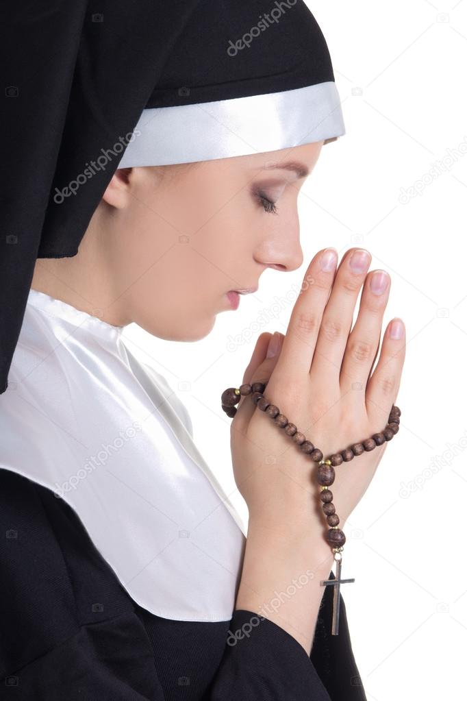 beautiful woman nun praying with rosary isolated on white