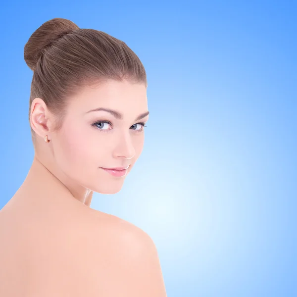 Portrait of young beautiful woman with perfect skin over blue — Stock Photo, Image